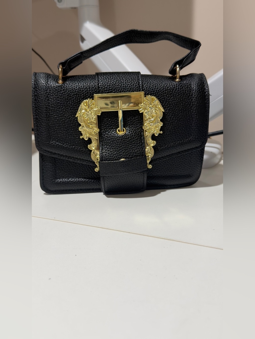 Black Leather Top-Handle Bag with Ornate Gold Buckle